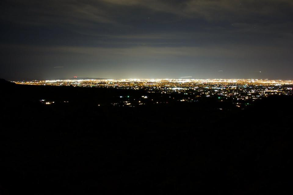 Just as with light pollution, the more development there is on Earth and in the sky, the more radio interference there will be. <a href="https://commons.wikimedia.org/wiki/File:San_Tan_Mountain_Lights.jpg" rel="nofollow noopener" target="_blank" data-ylk="slk:Gppercy/Wikimedia Commons;elm:context_link;itc:0;sec:content-canvas" class="link ">Gppercy/Wikimedia Commons</a>, <a href="http://creativecommons.org/licenses/by-sa/4.0/" rel="nofollow noopener" target="_blank" data-ylk="slk:CC BY-SA;elm:context_link;itc:0;sec:content-canvas" class="link ">CC BY-SA</a>