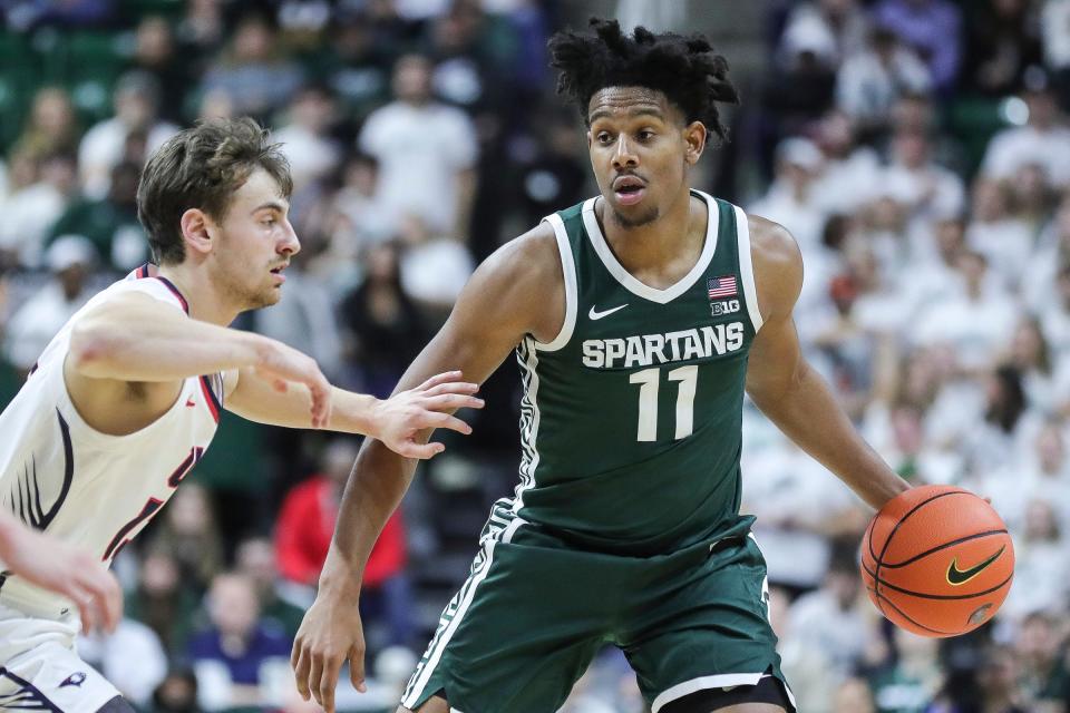 Michigan State guard A.J. Hoggard looks to pass against Southern Indiana guard Sam Mervis during the second half at Breslin Center in East Lansing on Thursday, Nov. 9, 2023.