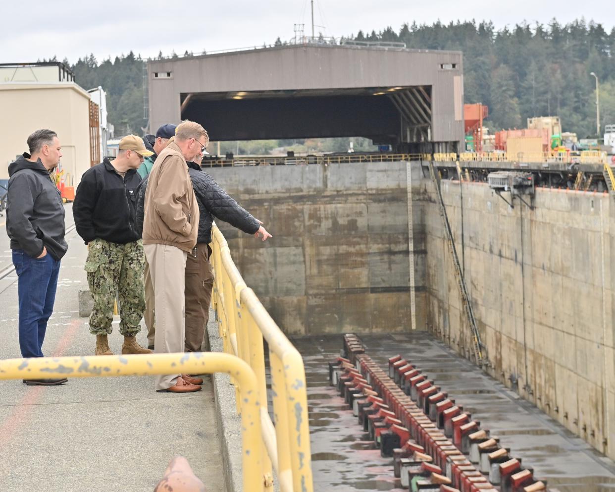 A group from the program management office for the Columbia-class ballistic missile submarine visits the dry dock at Trident Refit Facility Bangor (TRFB) on Oct. 26, 2022. The visit centered on the upgrades needed in order to be ready to maintain the Columbia-class submarines scheduled to enter service in the coming years. TRFB employs more than 2,000 civilian and military personnel in support of the nation’s strategic deterrent mission by repairing, incrementally overhauling, and modernizing ballistic missile subs in the Pacific Fleet.