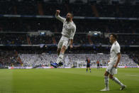 Real Madrid's Dani Carvajal, left, celebrates after Valencia's Daniel Wass scored an own goal during a Spanish La Liga soccer match between Real Madrid and Valencia at the Santiago Bernabeu stadium in Madrid, Spain, Saturday, Dec. 1, 2018. (AP Photo/Paul White)