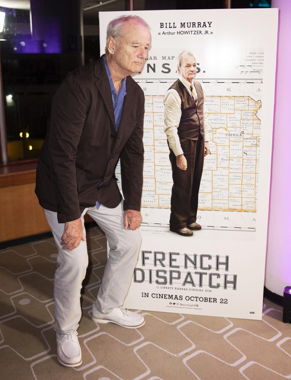 <p>Bill Murray poses with his movie poster at the U.K. premiere of his film <em>The French Dispatch</em> on Oct. 10 in London.</p>