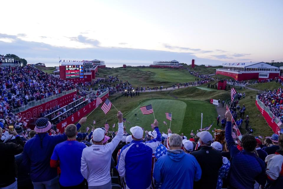 Fans wait on the first tee for the first group to tee off before a foursomes match the Ryder Cup at the Whistling Straits Golf Course Saturday, Sept. 25, 2021, in Sheboygan, Wis. (AP Photo/Ashley Landis)