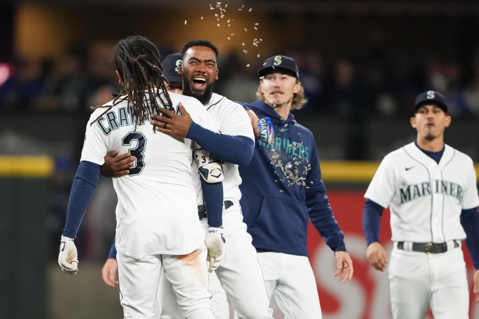 Seattle Mariners' J.P. Crawford (3) celebrates his game-winning, two-run double against the Texas Rangers with Teoscar Hernández, second from left, during the ninth inning of a baseball game Thursday, Sept. 28, 2023, in Seattle. (AP Photo/Lindsey Wasson)