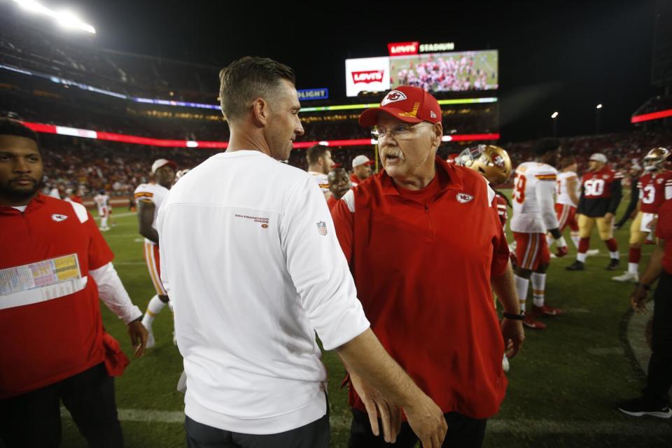 Chiefs coach Andy Reid (right) and 49ers coach Kyle Shanahan talk on the field after a game in 2021.