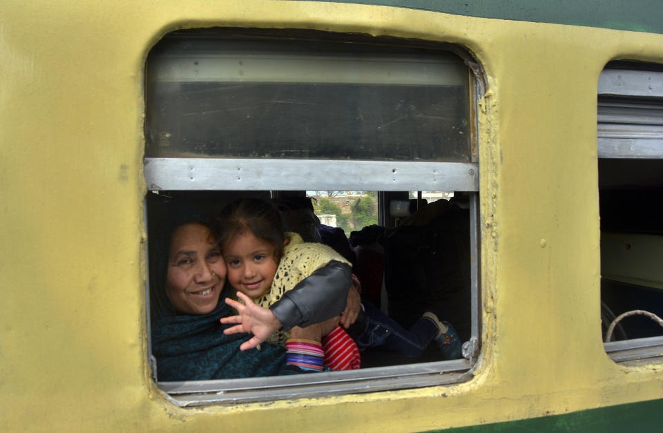 A young passenger from Pakistan waves to media from the Samjhauta Express train as it arrives in Atari, India, Monday, March 4, 2019. A Pakistani railway official said the key train service with neighboring India has resumed in another sign of easing tensions between the two nuclear-armed rivals since a major escalation last week over disputed Kashmir region. (AP Photo/Prabhjot Gill)