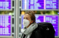 Flight passenger wears a protective mask at Frankfurt Airport