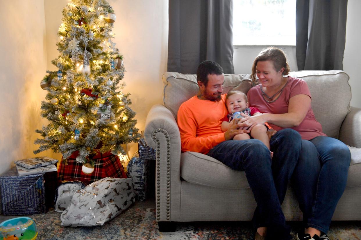 Craig Siringer and Ashley Wedig with their son, Troy, 1, at their home in Englewood.