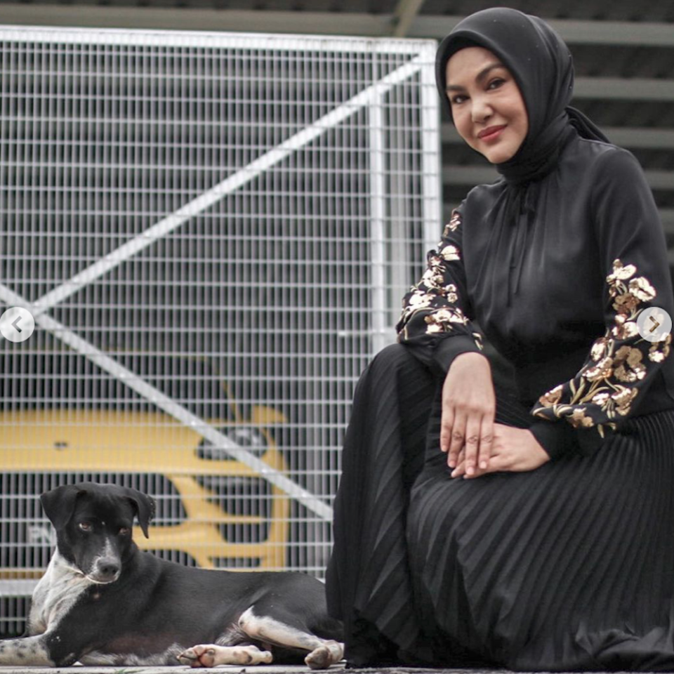 Umie Aida posing with Blackie, a female stray that she developed a close bond with since they crossed paths five years ago. — Picture from Instagram/myforeverdoggo