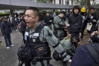 Riot police perform body search on a man ahead of a rally demanding electoral democracy and call for boycott of the Chinese Communist Party and all businesses seen to support it in Hong Kong, Sunday, Jan. 19, 2020. Hong Kong has been wracked by often violent anti-government protests since June, although they have diminished considerably in scale following a landslide win by opposition candidates in races for district councilors late last year. (AP Photo/Ng Han Guan)