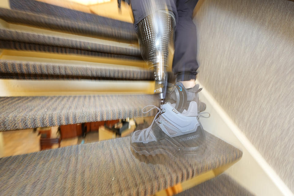 Denver Police Department Sgt. Justin Dodge hurries up the stairs on his prosthetic leg during a training exercise Friday, June 7, 2024, in a former athletic club now vacant in Lone Tree, Colo. Dodge, a SWAT team supervisor who lost his left leg below the knee after being run over by a firetruck during the Denver Nuggets' championship parade last June, is back on the job and makes it his mission to inspire others. (AP Photo/David Zalubowski)