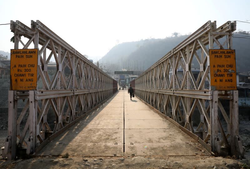 A person walks on a bridge that connects Myanmar and India at the border village of Zokhawthar