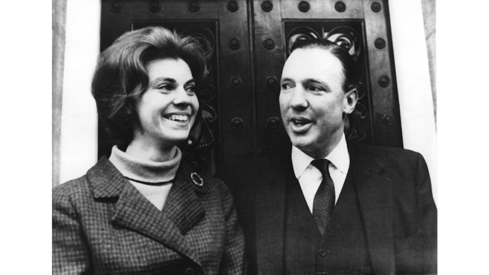 Black-and-white Princess Margaretha and John Ambler in front of a door