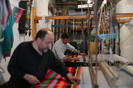 People work at a textile manufacturing shop in the old city of Tripoli, Libya April 13, 2019. Picture taken April 23, 2019. REUTERS/Ahmed Jadallah