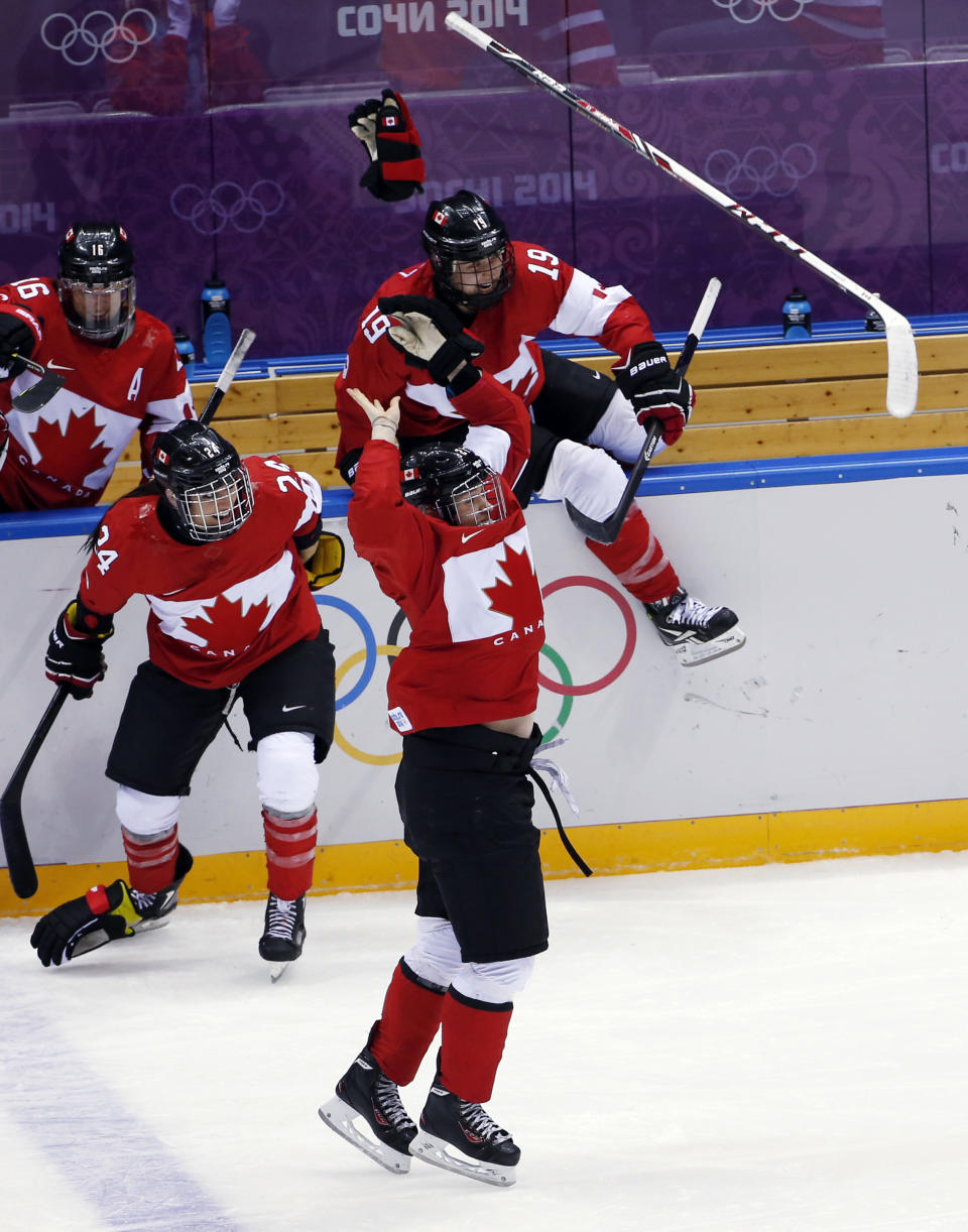 The Canada bench erupts after Marie-Philip Poulin of Canada (29) scores the game-winning goal in overtime against the USA during women's gold medal ice hockey game at the 2014 Winter Olympics, Thursday, Feb. 20, 2014, in Sochi, Russia. (AP Photo/Petr David Josek)