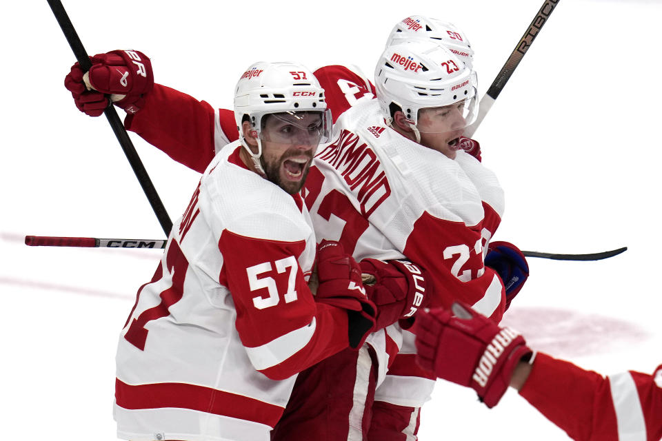 Detroit Red Wings' Lucas Raymond (23) celebrates after his goal with David Perron (57) during the first period of an NHL hockey game against the Pittsburgh Penguins in Pittsburgh, Sunday, March 17, 2024. (AP Photo/Gene J. Puskar)