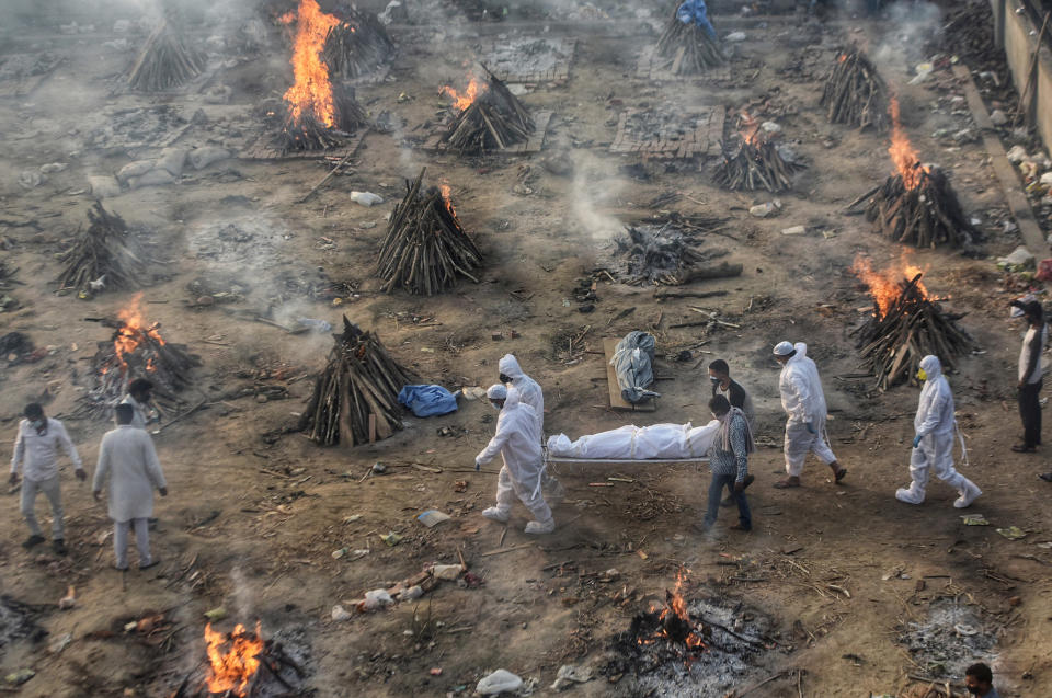 Image: Covid-19 victims being cremated at Seemapuri crematorium in New Delhi, India (Amal KS / Hindustan Times / Getty Images)