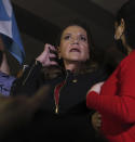 Honduras' President-elect Xiomara Castro, center, looks at supporters of her Liberty and Refoundation Party gathered in Tegucigalpa, Honduras, Saturday, Jan. 22, 2022. Castro saw her prospects of a successful administration take a hit even before she's been inaugurated, as a battle for leadership of the newly elected Congress devolved into shouting and shoving among her own allies on Friday. (AP Photo/Elmer Martinez)