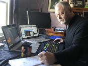 In this image provided by Robert Moran, Robert Moran, Managing Director at Mark J. Muller Equities, Inc., who normally works on the New York Stock Exchange trading floor, works in his home office in Millstone Township, N.J., Tuesday, March 24, 2020, because the floor is temporarily closed. Stocks are jumping in morning trading on Wall Street Tuesday amid expectations that Congress is nearing a deal on a big coronavirus relief bill. (Courtesy Robert Moran via AP)