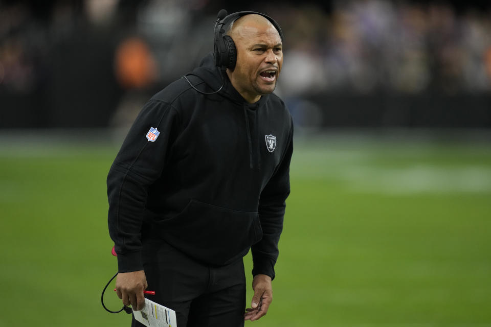 Las Vegas Raiders interim head coach Antonio Pierce makes a call during the first half of an NFL football game against the Minnesota Vikings, Sunday, Dec. 10, 2023, in Las Vegas. (AP Photo/John Locher)