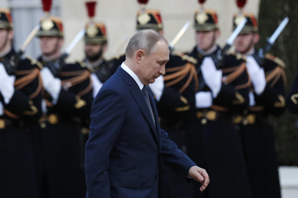 Russian President Vladimir Putin walks past Republican guards as he arrives at the Elysee Palace Monday, Dec. 9, 2019 in Paris. A long-awaited summit in Paris is aiming to find a way to end the war in Ukraine, after five years and 14,000 lives lost in a conflict that has emboldened the Kremlin and reshaped European geopolitics. (AP Photo/Thibault Camus)