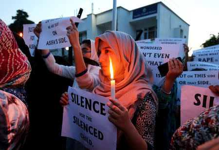 Students participate in a candle light procession as they protest against the rape and murder of an eight-year-old girl in Kathua, in Jammu, April 13, 2018. REUTERS/Mukesh Gupta