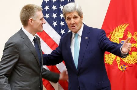 U.S. Secretary of State John Kerry (R) meets Montenegro's Foreign Minister Igor Luksic at the NATO ministerial meetings at NATO Headquarters in Brussels December 2, 2015. REUTERS/Jonathan Ernst