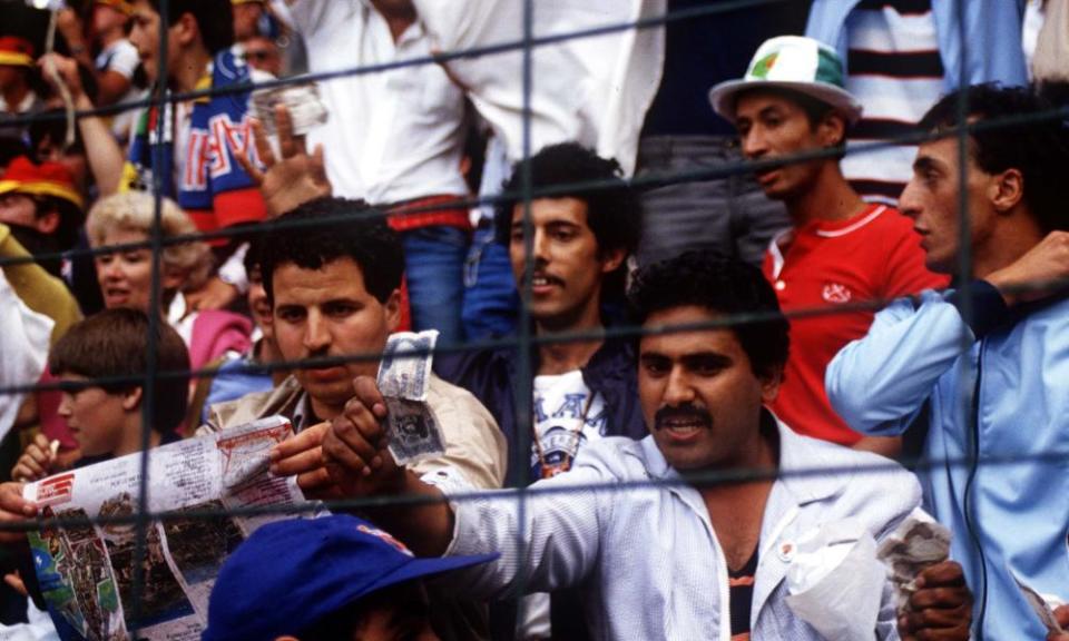 An Algeria fan waves a bank note to allege that West Germany’s draw with Austria, which eliminated Algeria, was fixed.