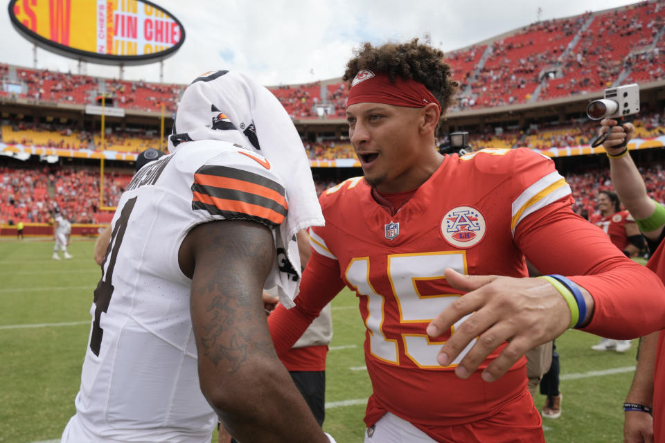 Kansas City Chiefs quarterback Patrick Mahomes (15) hugs Cleveland Browns quarterback Deshaun Watson following an NFL preseason football game Saturday, Aug. 26, 2023, in Kansas City, Mo. The Chiefs won 33-32. (AP Photo/Charlie Riedel)