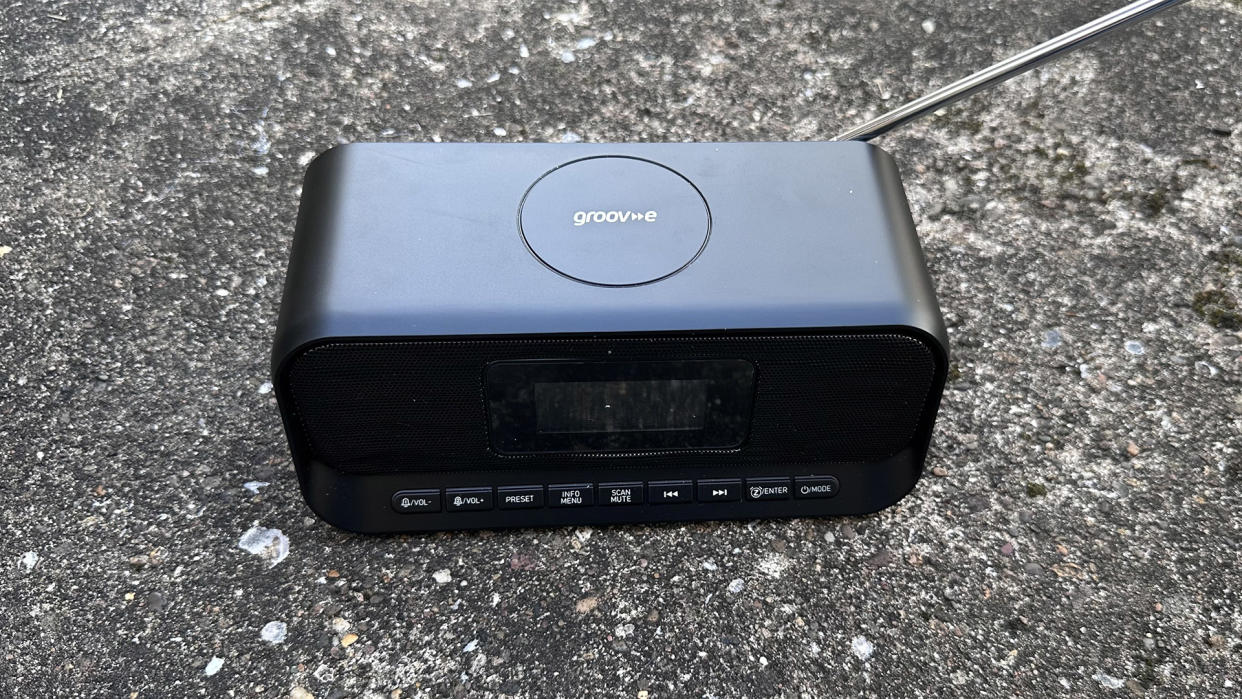  The Groov-E-Zeus DAB FM radio clock against cement  