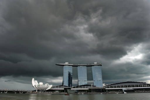 Dark clouds form a backdrop against Singapore's iconic Marina Bay Sands casino and hotel resort complex. (AFP photo)