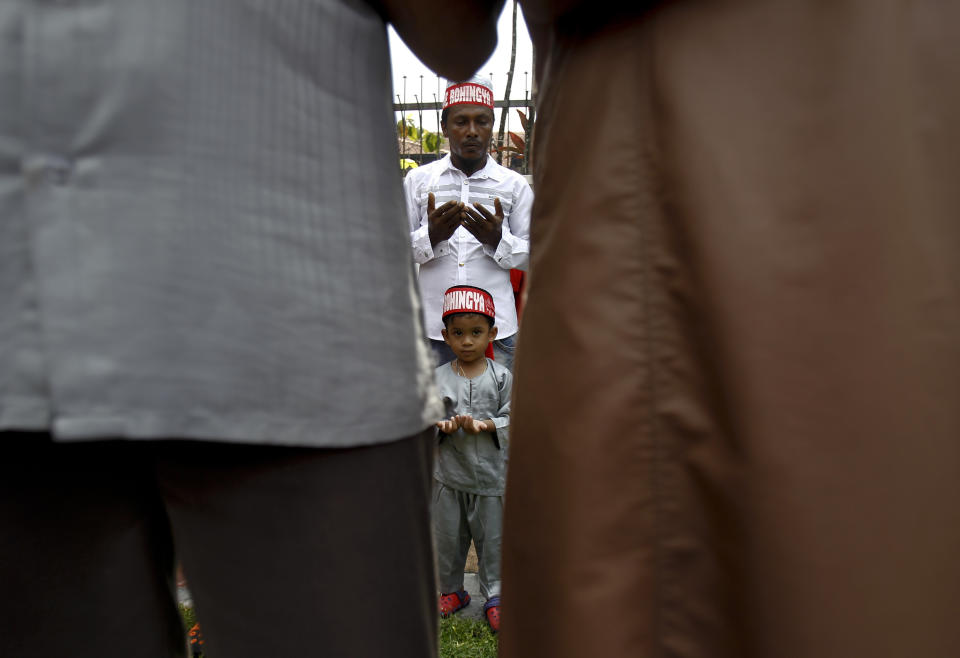 <p>A Rohingya Muslim man and his son prays during a protest outside the Myanmar Embassy in Kuala Lumpur, Malaysia on Friday, Sept. 8, 2017. (Photo: Daniel Chan/AP) </p>