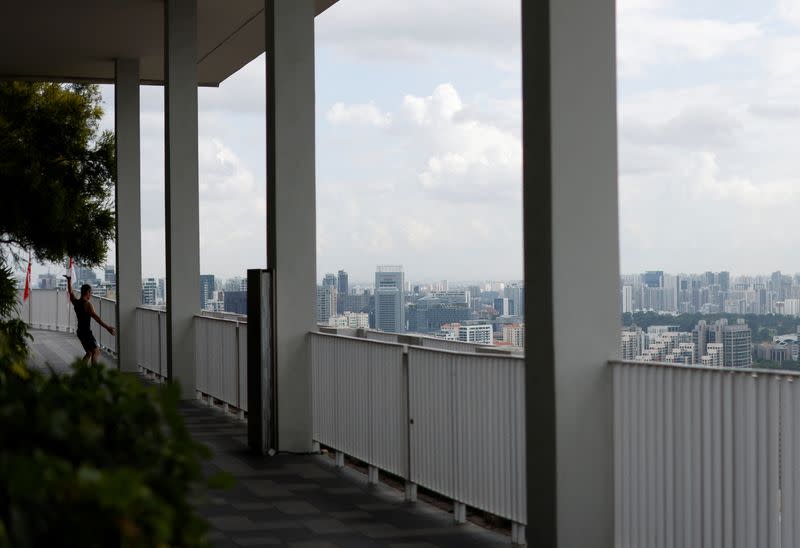 A man exercises on the sky deck of the Pinnacle at Duxton public housing apartment blocks in Singapore