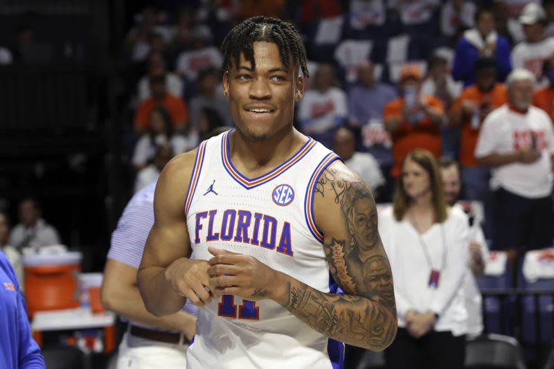 FILE – Florida forward Keyontae Johnson (11) smiles after being introduced as a starter before the first half of an NCAA college basketball game against Kentucky, on March 5, 2022, in Gainesville, Fla. Johnson, who collapsed during a game in December 2020, is headed to Kansas State to resume his college career. Johnson made the announcement on social media on Saturday, Aug. 20, 2022, and chose the Wildcats over fellow finalists Memphis, Nebraska and Western Kentucky. (AP Photo/Matt Stamey, File)
