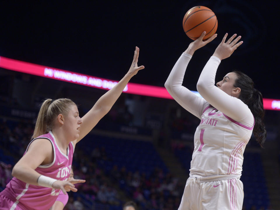 Penn State's Ali Brigham (1) shoots from the baseline on Monika Czinano (25) Iowa's during the first half of an NCAA college basketball game, Sunday, Feb. 5, 2023, in State College, Pa. (AP Photo/Gary M. Baranec)