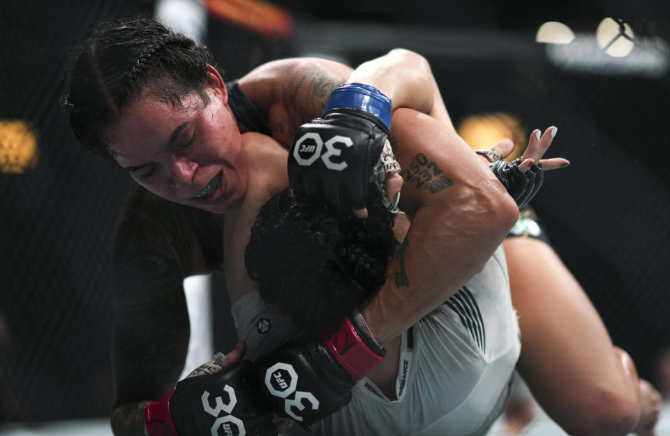 Amanda Nunes, top left, and Irene Aldana fight during a UFC 289 women's bantamweight title bout, in Vancouver, British Columbia, on Saturday, June 10, 2023. (Darryl Dyck/The Canadian Press via AP)