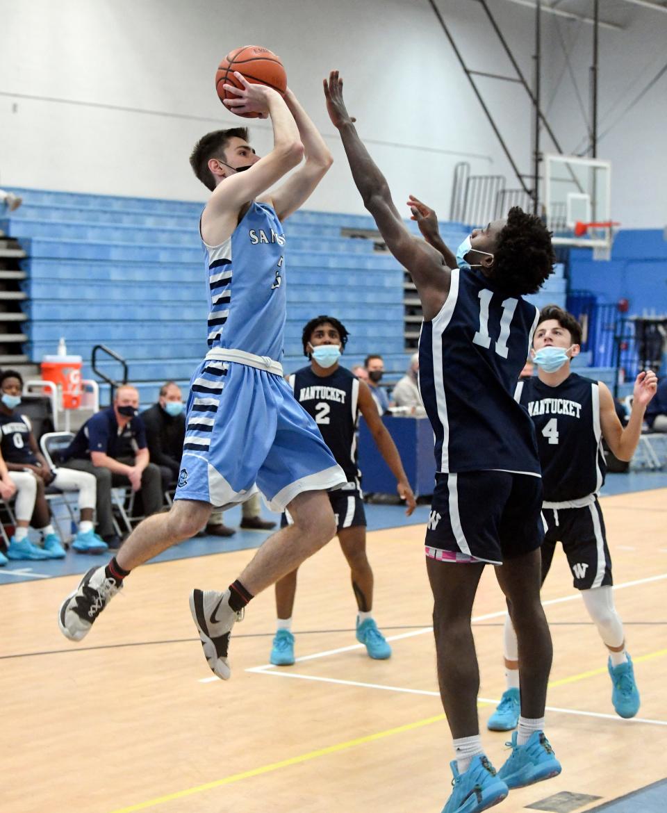 Sean Lansing of Sandwich puts up a shot defended by Karson Wellington of Nantucket in this December 2021 photo.