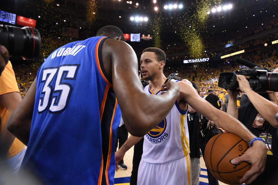 Warriors guard Stephen Curry (30) is congratulated by Oklahoma City Thunder forward Kevin Durant (35) after game seven of the Western conference finals of the NBA Playoffs at Oracle Arena.