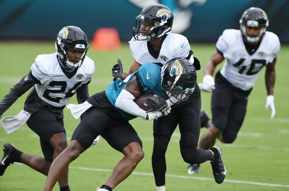 Jaguars WR #14, Terry Goodwin tries to get past CB #24, Josiah Scott and #3, Luq Barcoo during drills at Saturday's practice session. The Jacksonville Jaguars held a practice session and scrimmage at TIAA Bank Field in Jacksonville, Florida Saturday, August 29, 2020. Selected guests and members of the media were invited to the soft opening of the stadium with new accommodations made to help reduce the chance of spreading the coronavirus. Seating capacity is limited and much of the available seating has been closed off to encourage social distancing. There is little opportunity for physical contact with doors, food purchasing and shopping inside the stadium with cashless and online purchasing.  [Bob Self/Florida Times-Union]