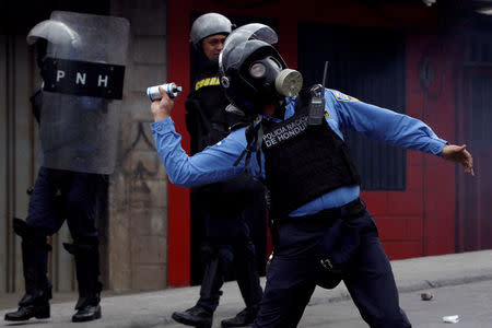 A riot police throws a tear gas canister to demonstrators, during a protest against the re-election of Honduras' President Juan Orlando Hernandez in Tegucigalpa, Honduras January 20, 2018. REUTERS/Jorge Cabrera