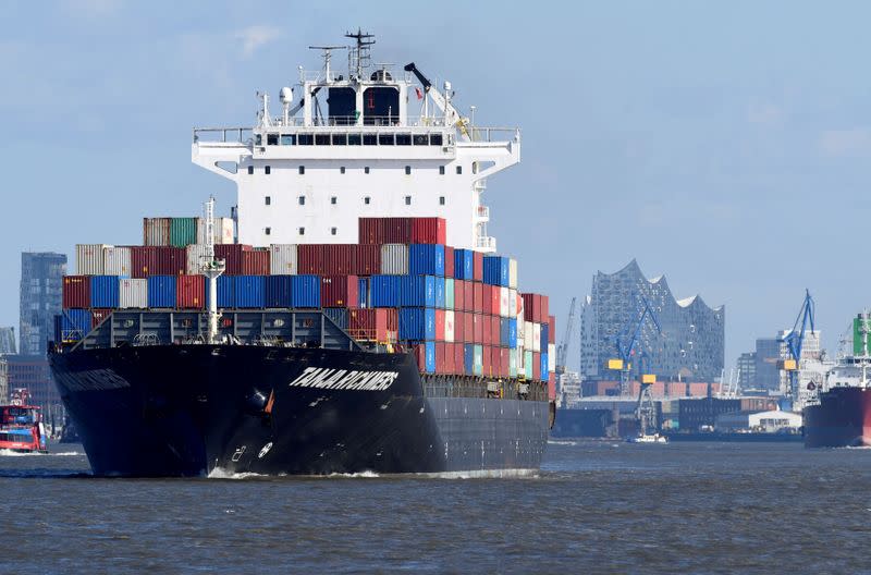 FILE PHOTO: A container ship leaves the port in front of famous landmark Philharmonic Hall in Hamburg