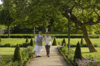 FILE - German Chancellor Angela Merkel, right, and Indian Prime Minister Narendra Modi, walk through the garden of the government guest house Meseberg Palace during a meeting in Meseberg, about 70 kilometers (43 miles) north on Berlin, May 29, 2017. Merkel has been credited with raising Germany’s profile and influence, helping hold a fractious European Union together, managing a string of crises and being a role model for women in a near-record tenure. Her designated successor, Olaf Scholz, is expected to take office Wednesday, Dec. 8, 2021. (AP Photo/Markus Schreiber, File)