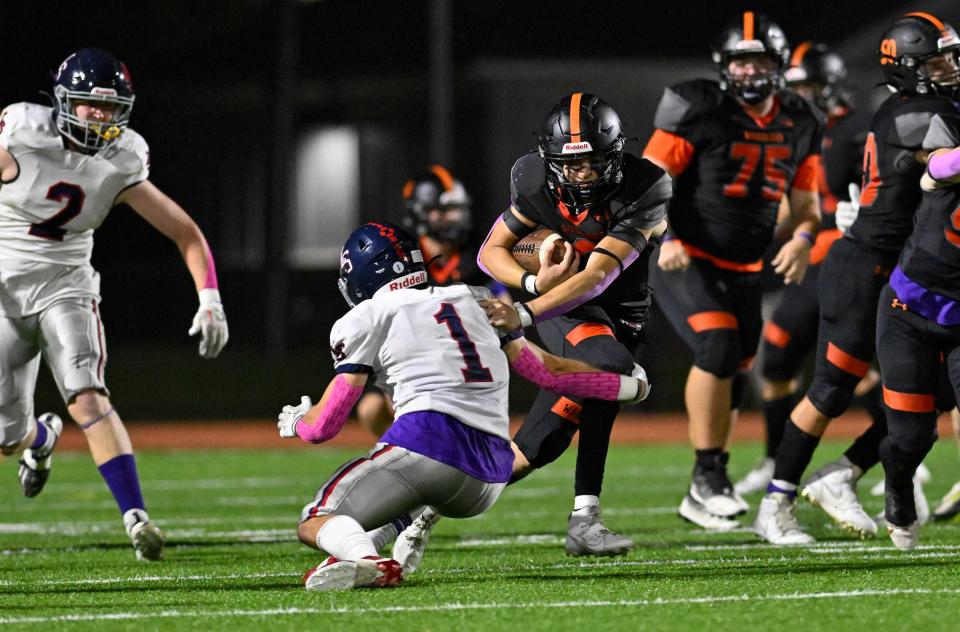 Wayland senior Jake Kennedy runs the ball past Lincoln-Sudbury senior captain Jake Haarde during a football game at Wayland High School, Friday, Oct. 6, 2023. Lincoln-Sudbury defeated Wayland 27-0.