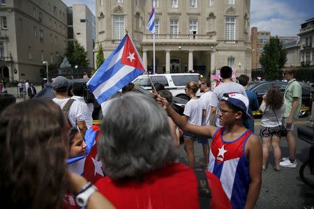 People gather outside the Cuban embassy after the Cuban flag was raised in a ceremony in Washington July 20, 2015. REUTERS/Jonathan Ernst