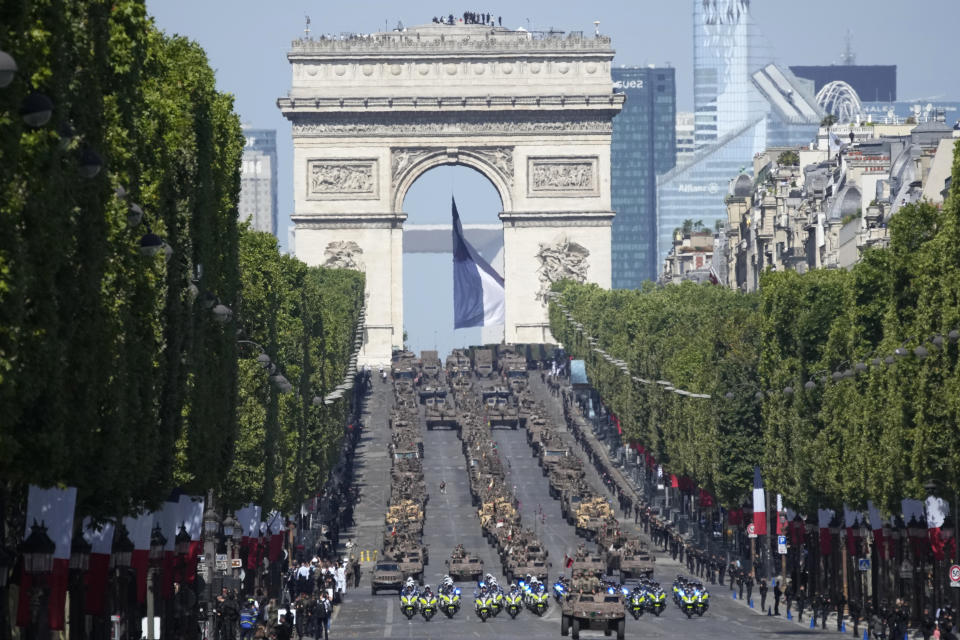 Soldiers drive military vehicles on the Champs-Elysees avenue during the Bastille Day parade in Paris, Friday, July 14, 2023. (AP Photo/Christophe Ena)