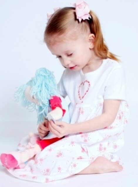 Girl playing with doll.