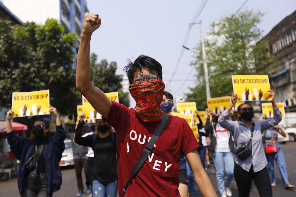 FILE - Anti-coup protesters gesture during a march in Yangon, Myanmar, Friday, March 26, 2021. As Feb. 1, 2023, marks two years after Myanmar’s generals ousted Aung San Suu Kyi’s elected government, thousands of people have died in civil conflict and many more have been forced from their homes in a dire humanitarian crisis. (AP Photo, File)