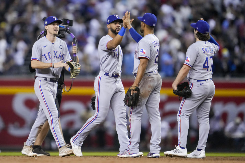 The Texas Rangers celebrate their win against the Arizona Diamondbacks in Game 4 of the baseball World Series Tuesday, Oct. 31, 2023, in Phoenix. The Rangers won 11-7. (AP Photo/Godofredo A. Vásquez)