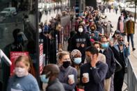 Voters line up to cast ballots on the first day of early voting in New York