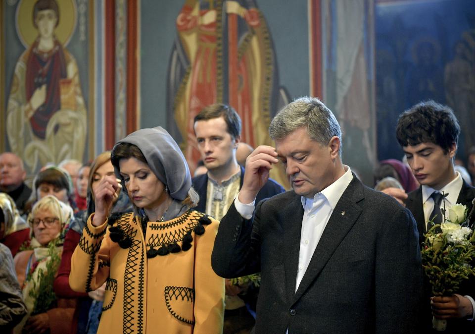 Ukrainian President Petro Poroshenko and his wife Maryna cross themselves during Orthodox Palm Sunday mass in the St. Michael's Monastery in Kiev, Ukraine, Sunday, April 21, 2019. Top issues in the election have been corruption, the economy and how to end the conflict with Russia-backed rebels in eastern Ukraine. (Mykola Lazarenko, Ukrainian Presidential Press Service/Pool Photo via AP)