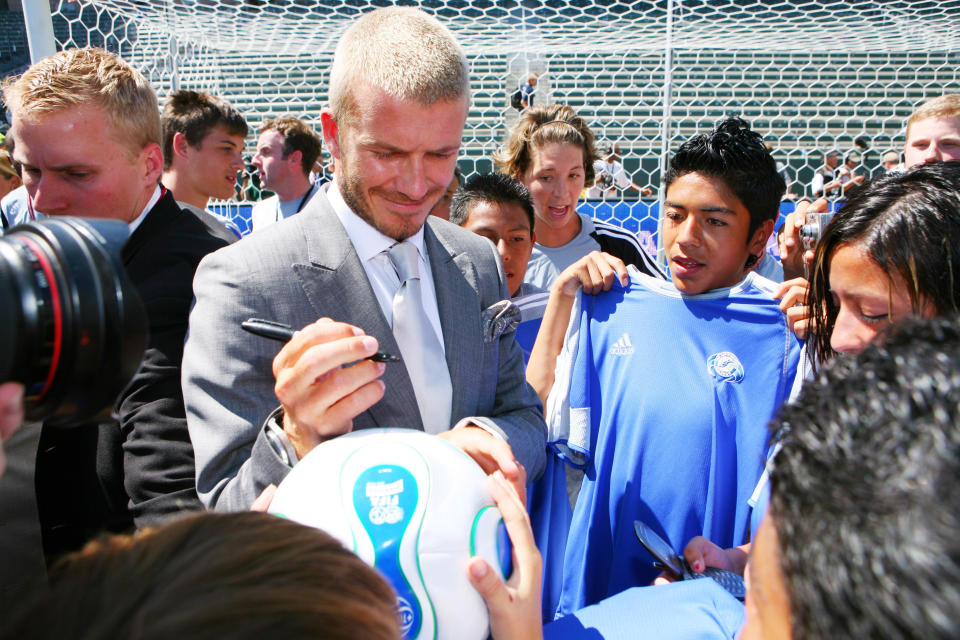 David Beckham poses signs autographs for young fans following to a press conference introducing him as the newest member of the Los Angeles Galaxy on July 13, 2007 at the Home Depot Center in Carson, CA.